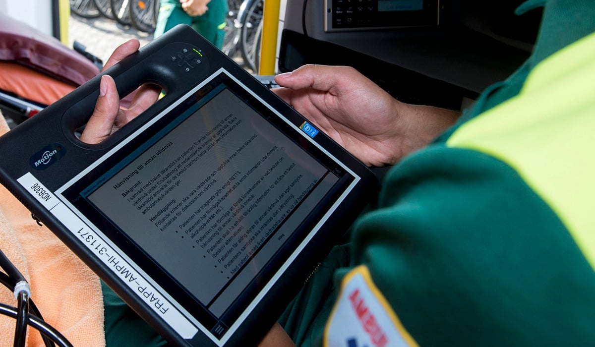 Medarbetare i ambulans skriver i patientjournal