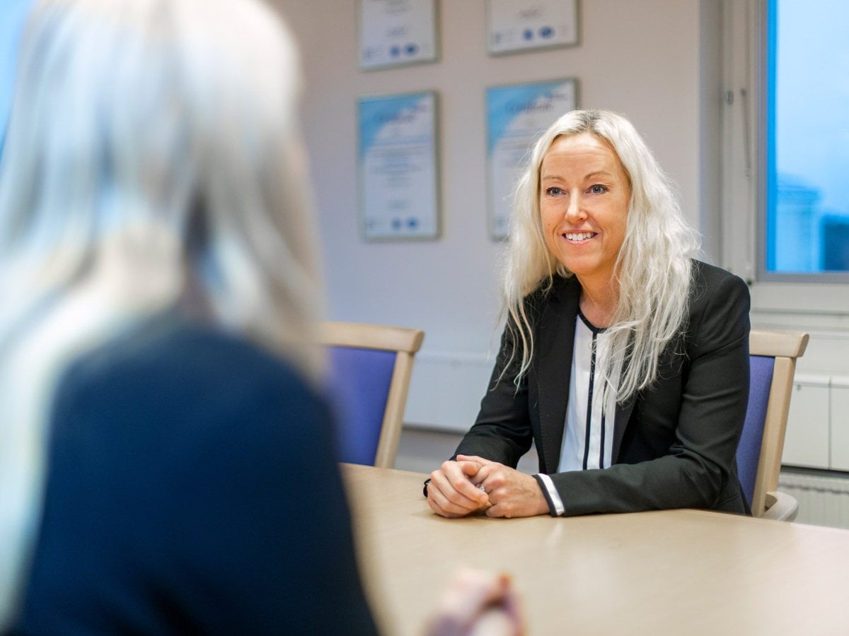 Två personer som sitter vid ett bord och samtalar